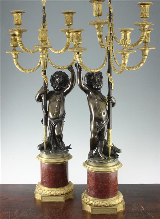 A pair of 19th century and later gilt brass and bronze figural candelabra, 35in.